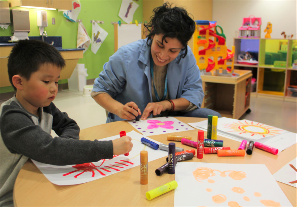 Volunteer Laura in the Playroom with a Patient